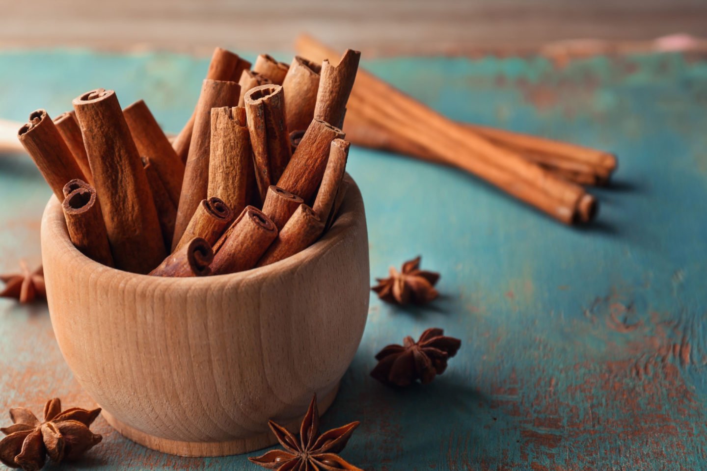 cinnamon sticks in wooden bowl