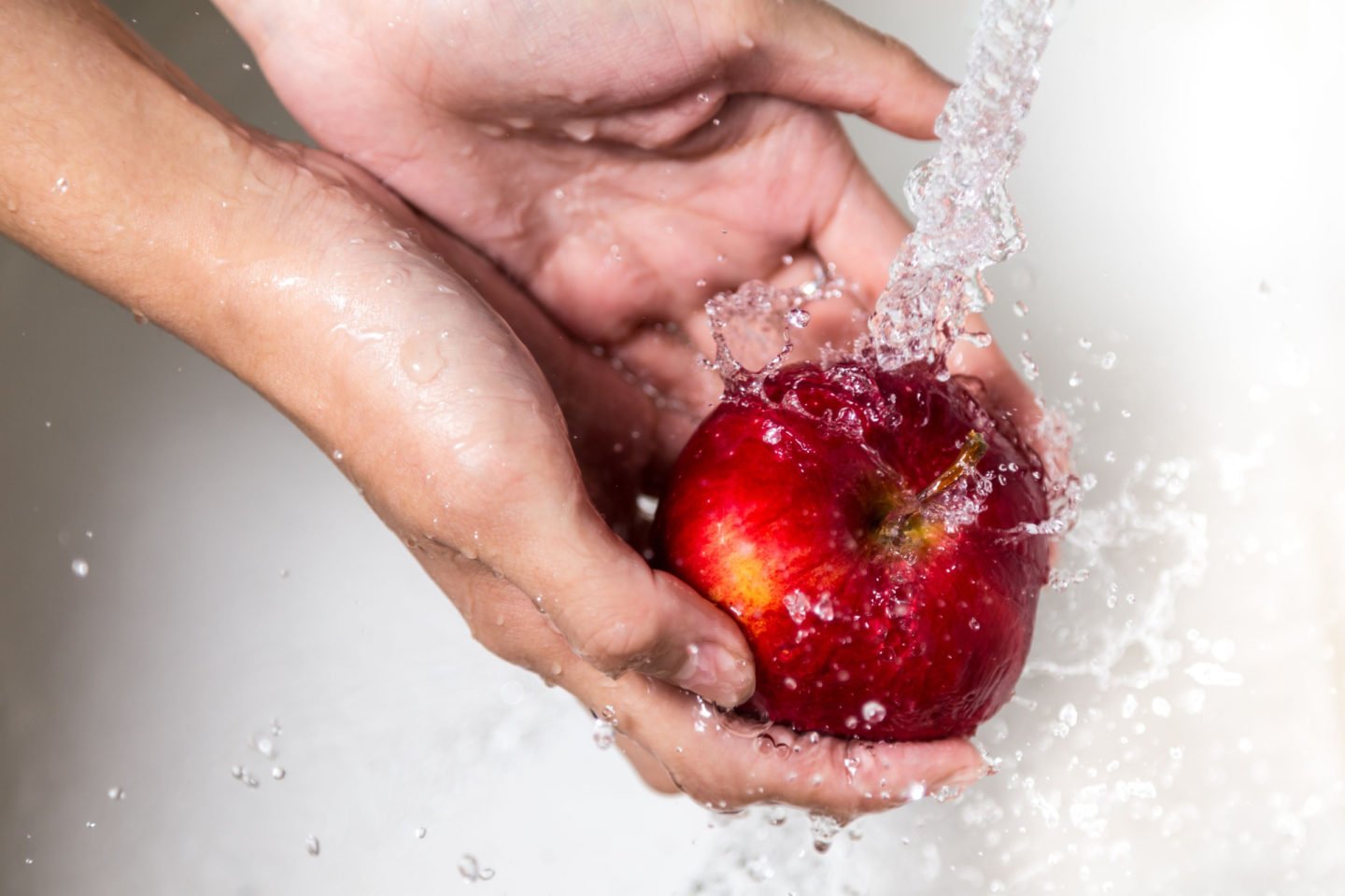 Female Hands Washing Apple Under Tap