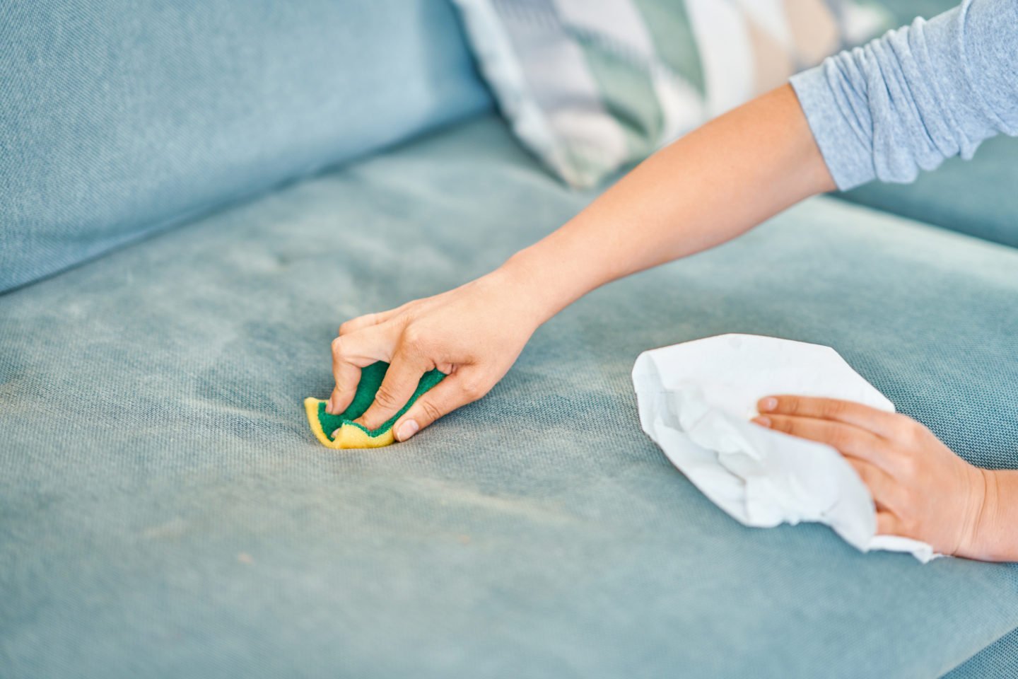 Woman Cleaning Sofa