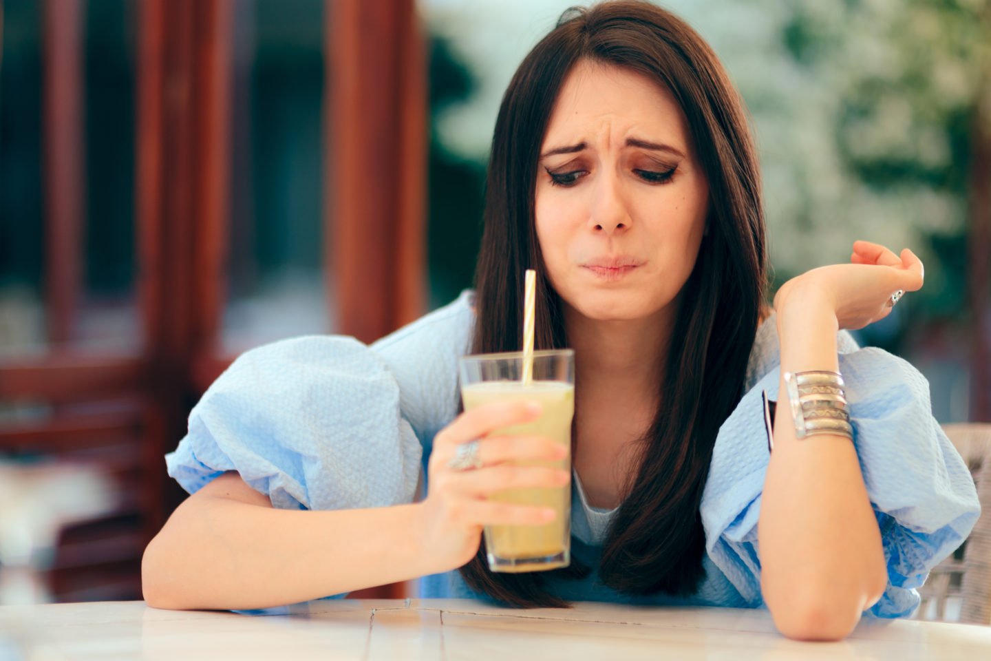 Woman Drinking Really Sour Lemon Juice