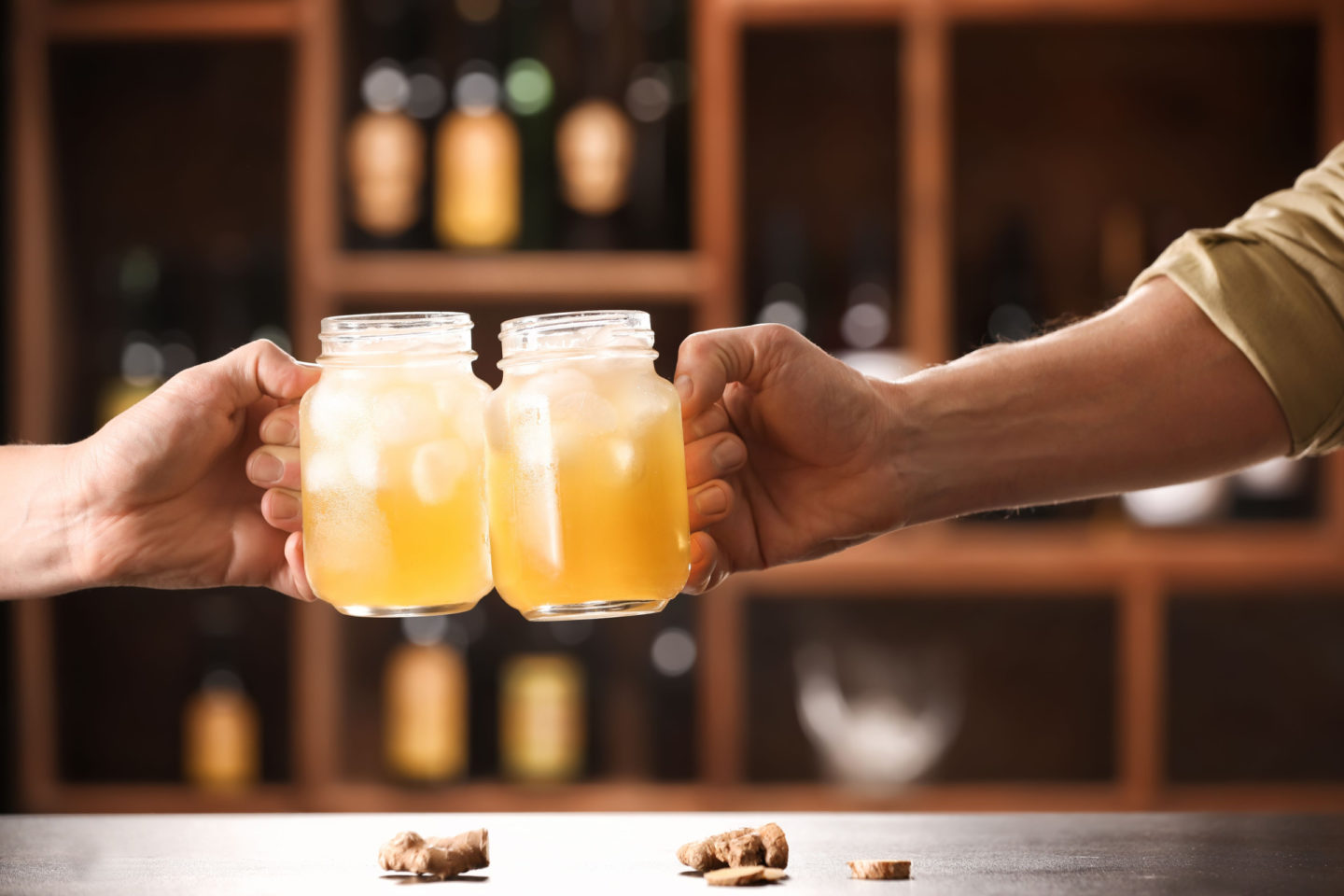 Men Holding Mugs Of Fresh Ginger Beer