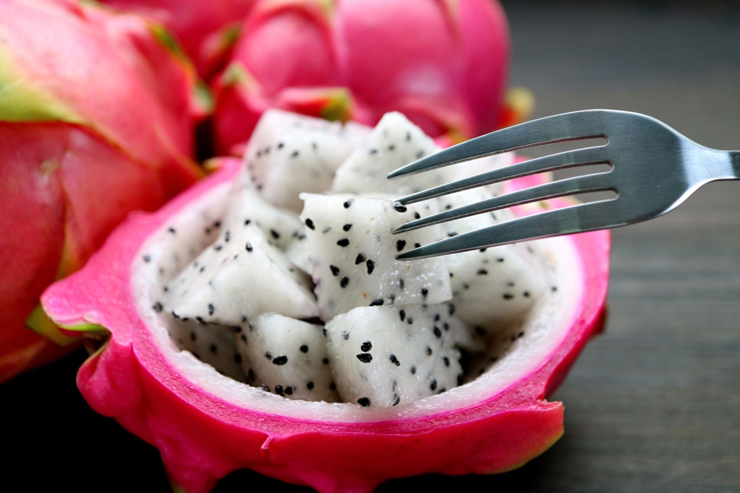 eating dragon fruit with fork