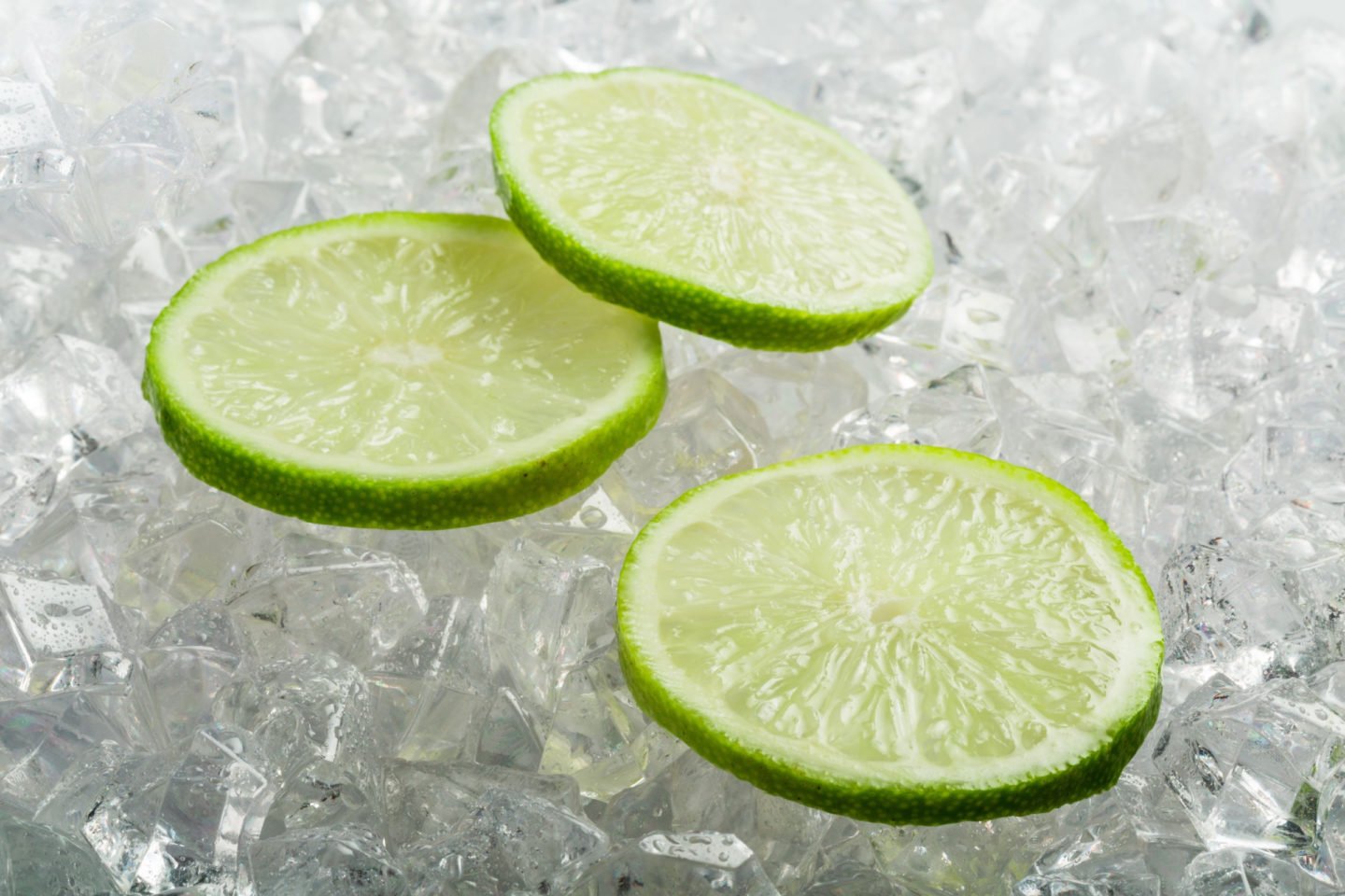fresh lime slices on ice