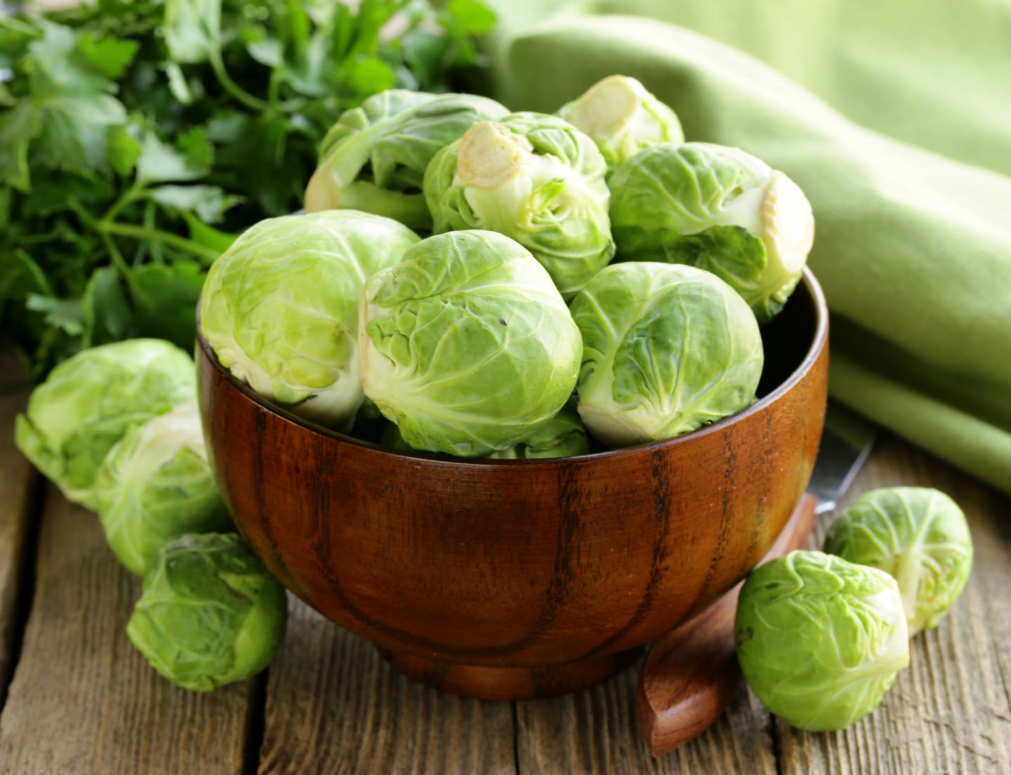 raw brussels sprouts in a wooden bowl