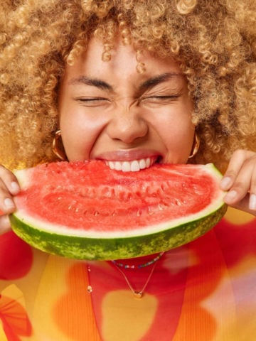 Young Woman Eating A Slice Of Watermelon 360x480
