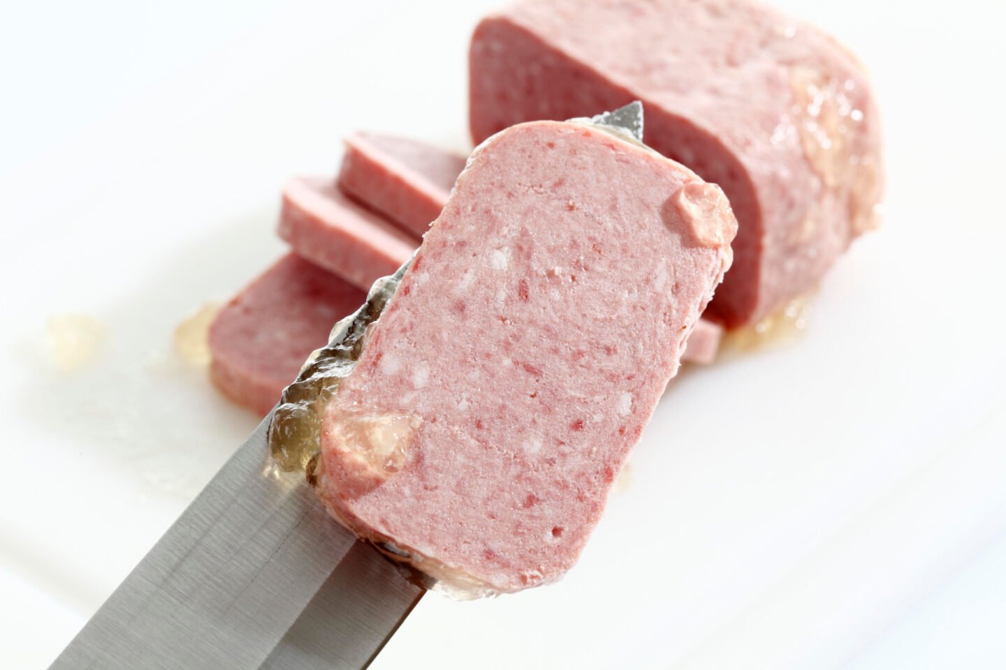 a slice of spam on a knife