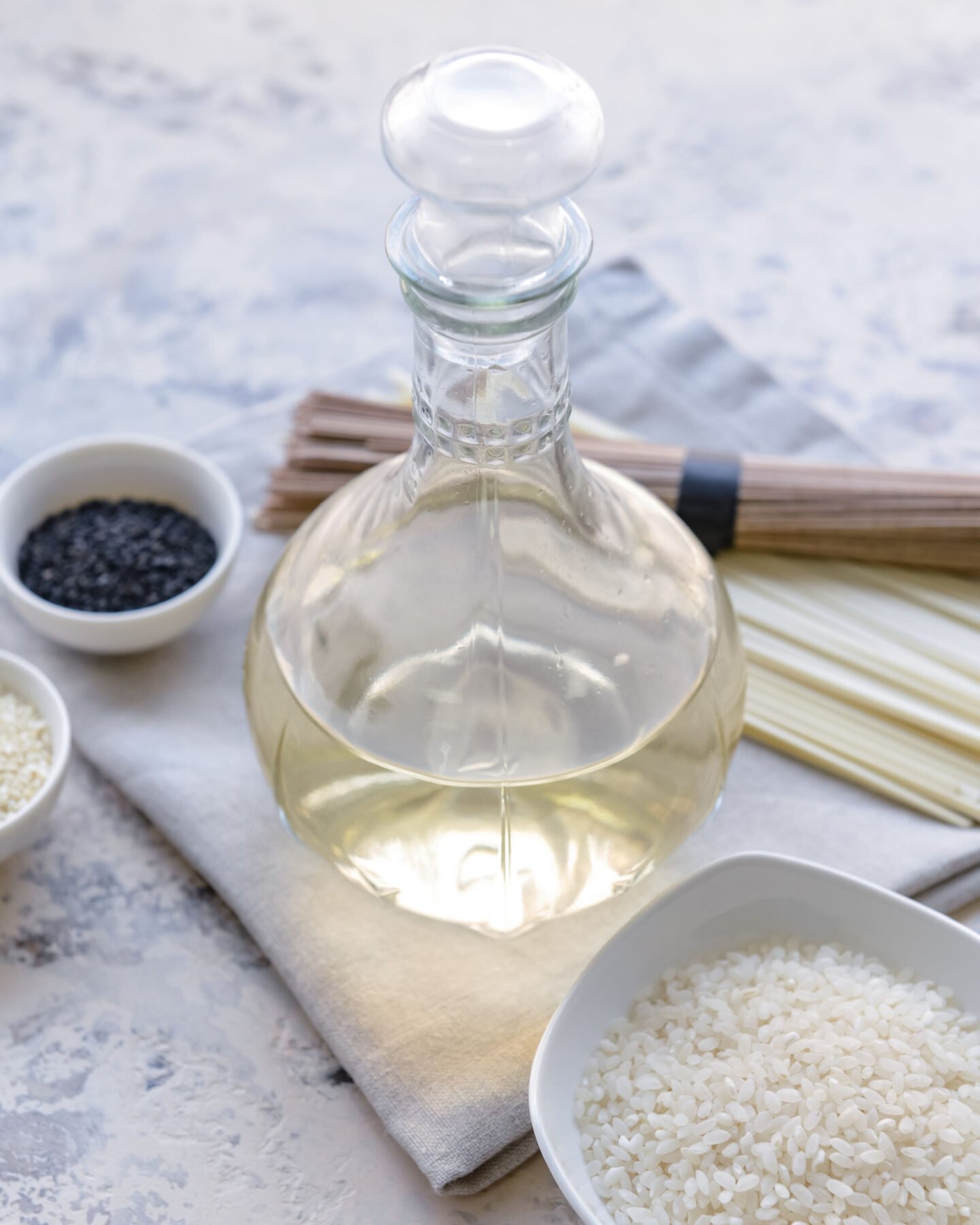 bottle of rice vinegar with raw rice grains
