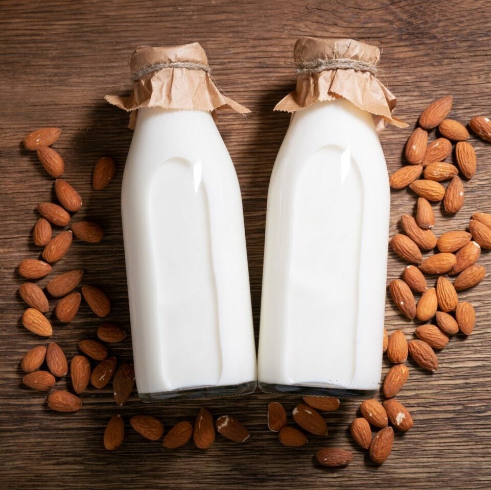 Bottles,Of,Almond,Milk,With,Almond,On,A,Wooden,Background,