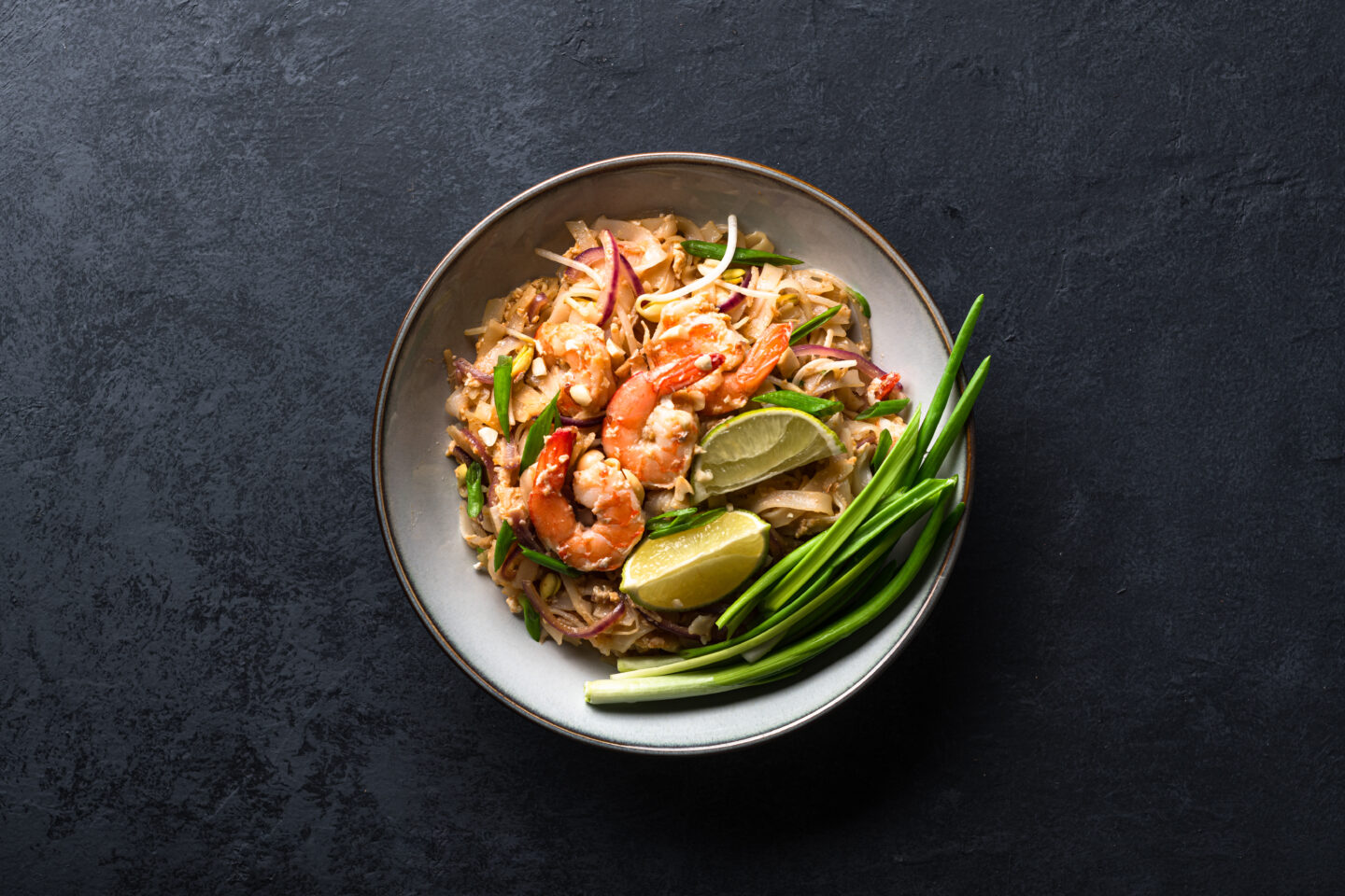 Pad,Thai,With,Shrimp,And,Vegetables,On,A,Dark,Background,