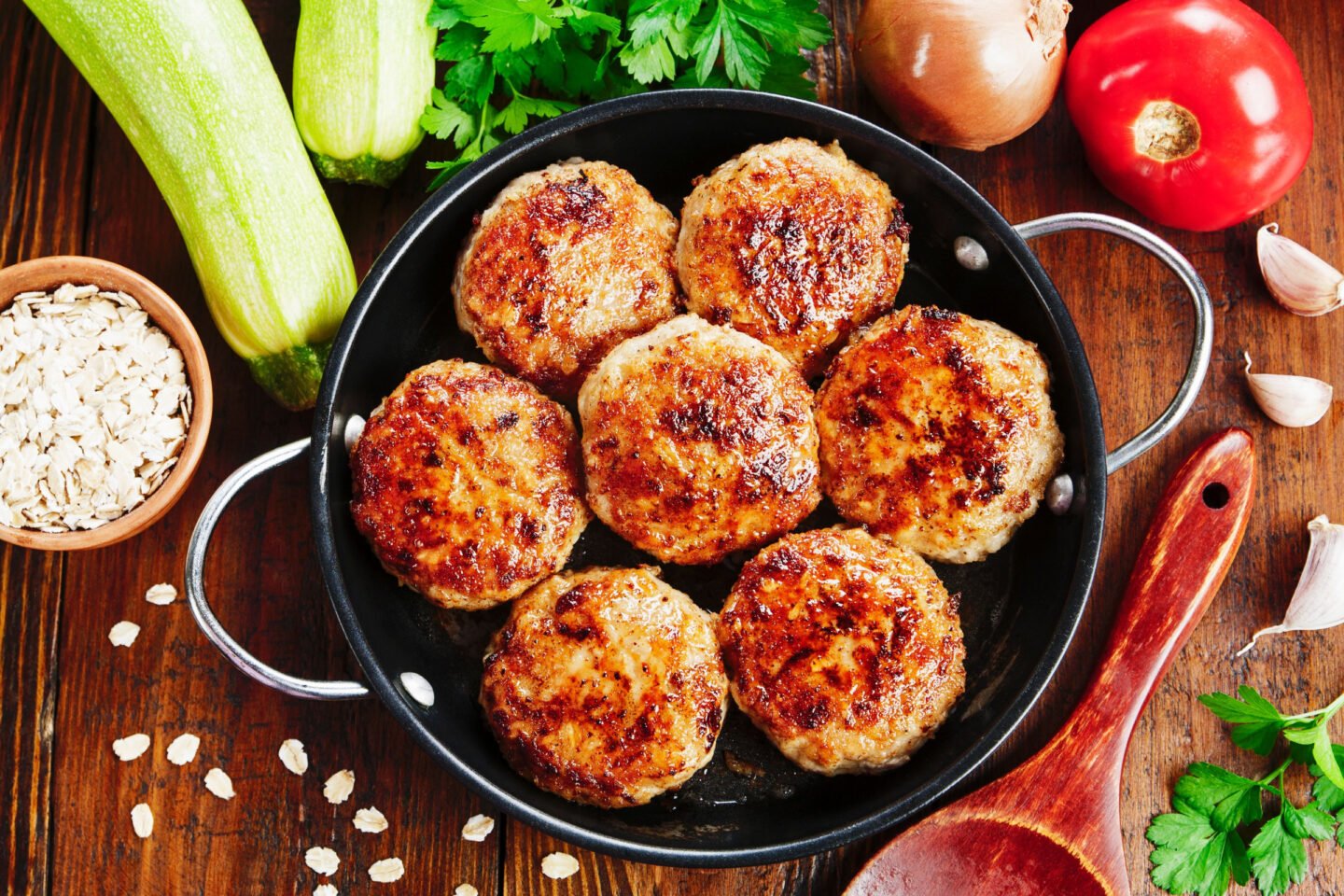 burgers with oatmeal and zucchini in the pan