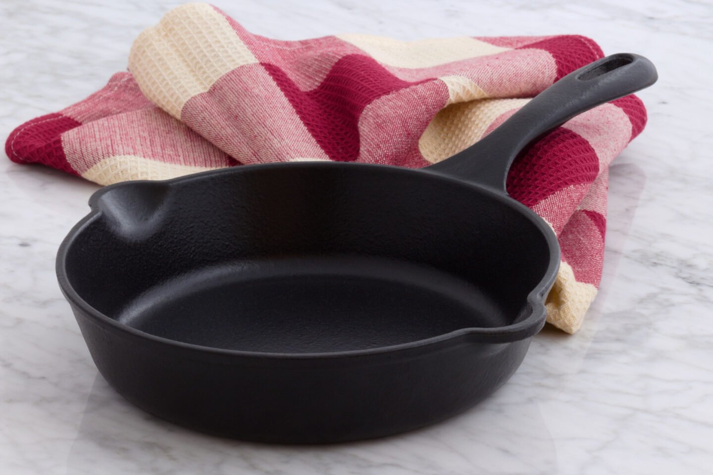 cast iron skillet with red table cloth