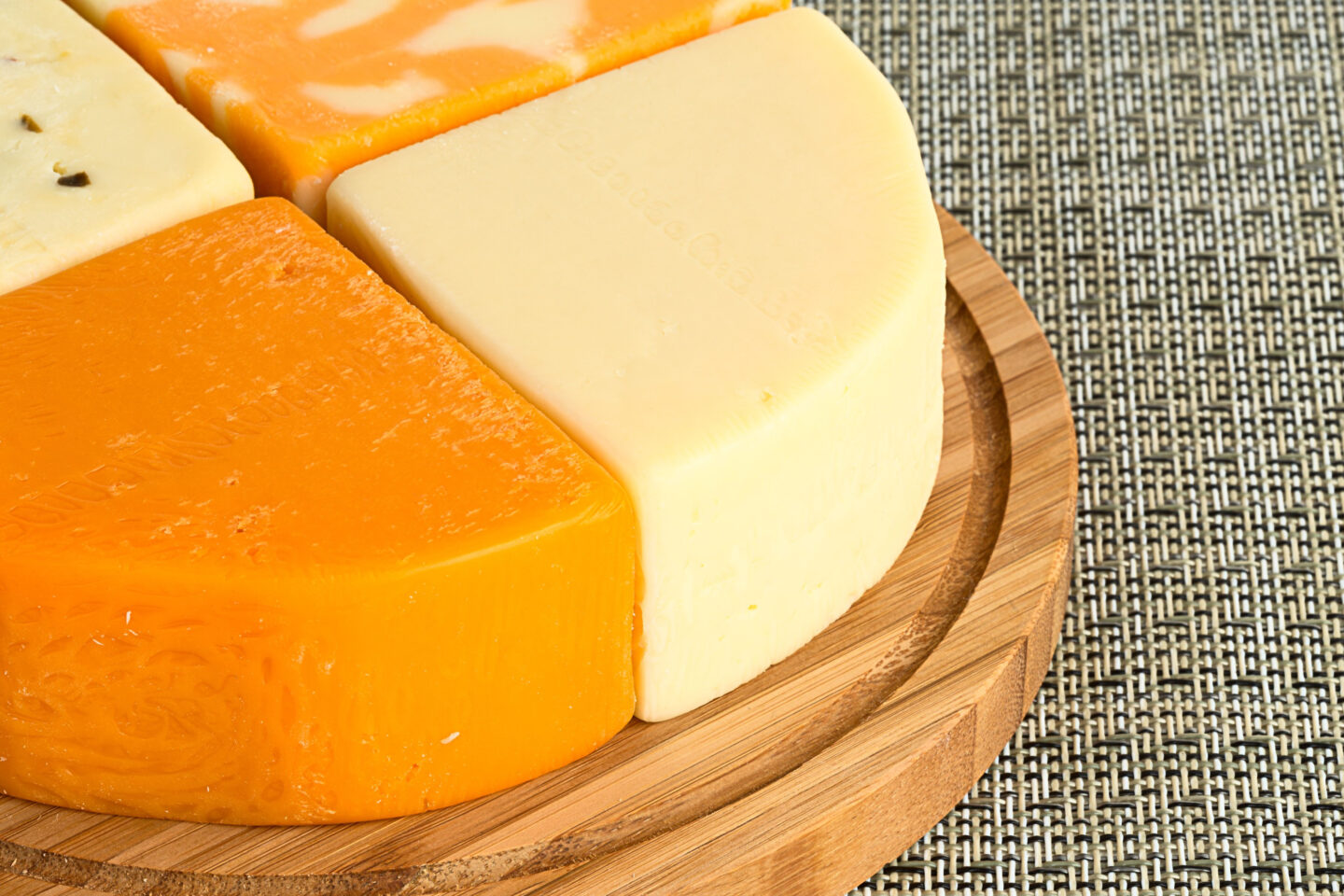 four types of cheese on wooden board