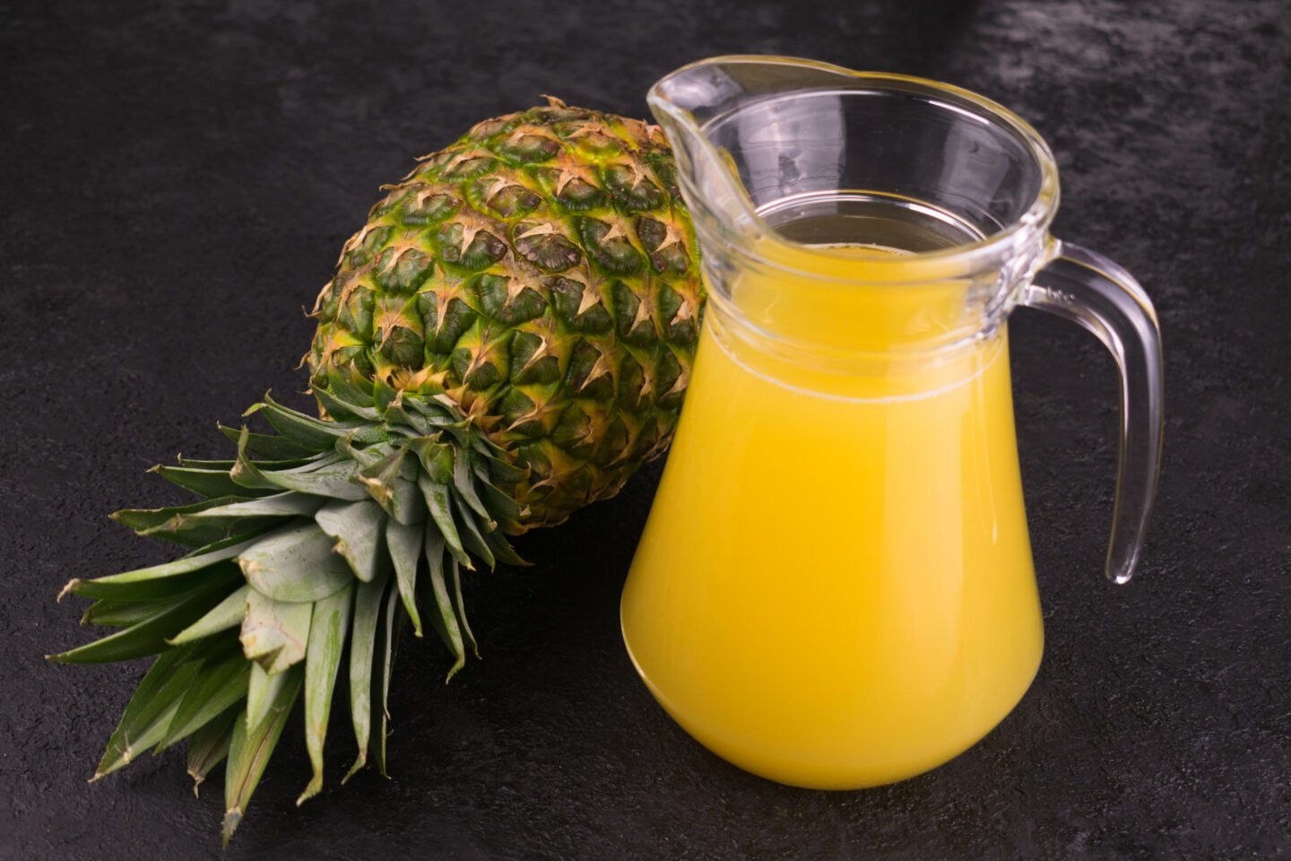 Carafe,With,Fresh,Pineapple,Juice,On,A,Black,Background.,Close up.