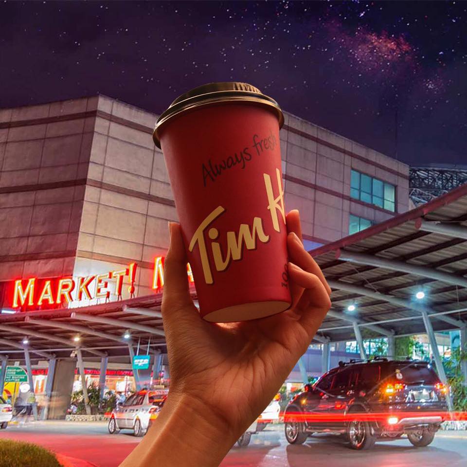 hand holding up double double in tim hortons takeaway cup
