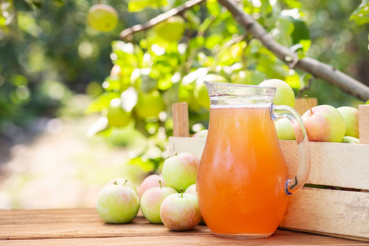 Apples,,Box,Of,Apples,And,Pitcher,Of,Fresh,Apple,Juice