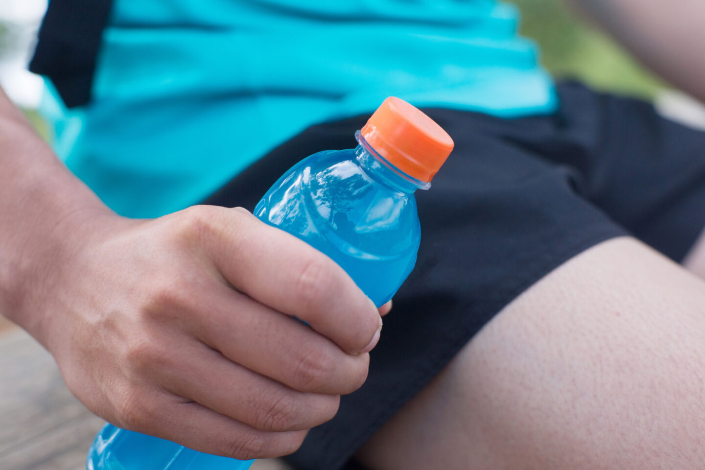 man holding a bottle of gatorade in his hand