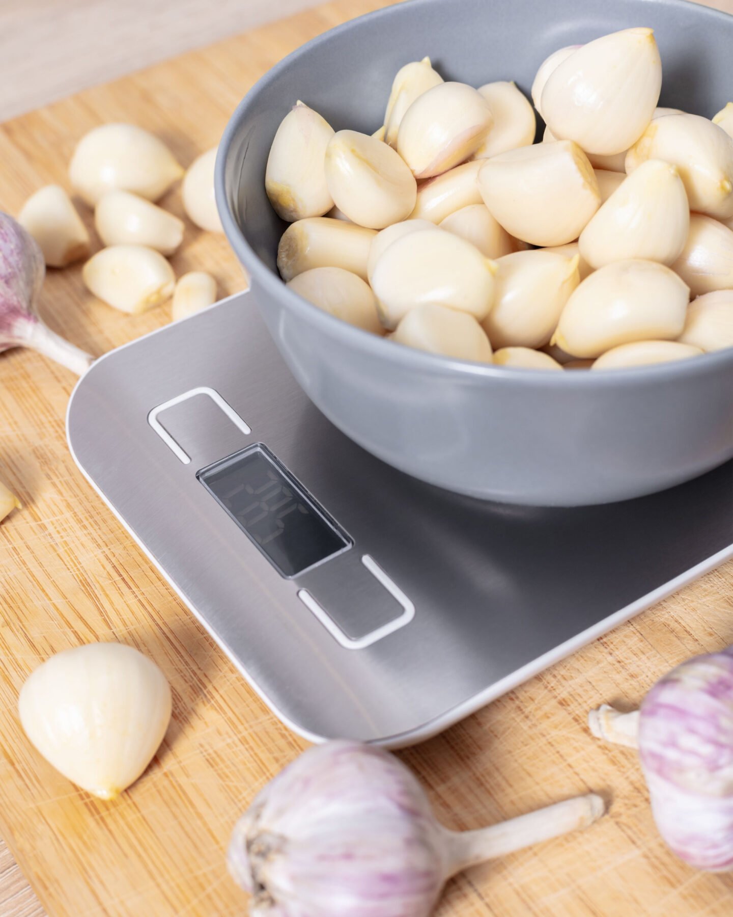 peeled garlic cloves on a kitchen scale