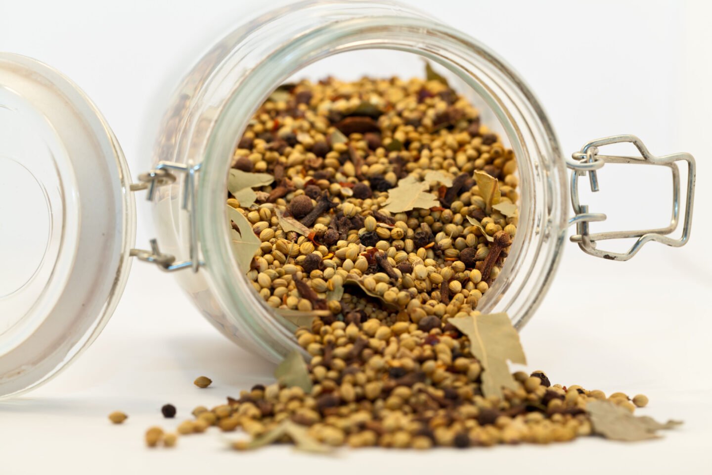 pickling spice blend spilling from glass jar