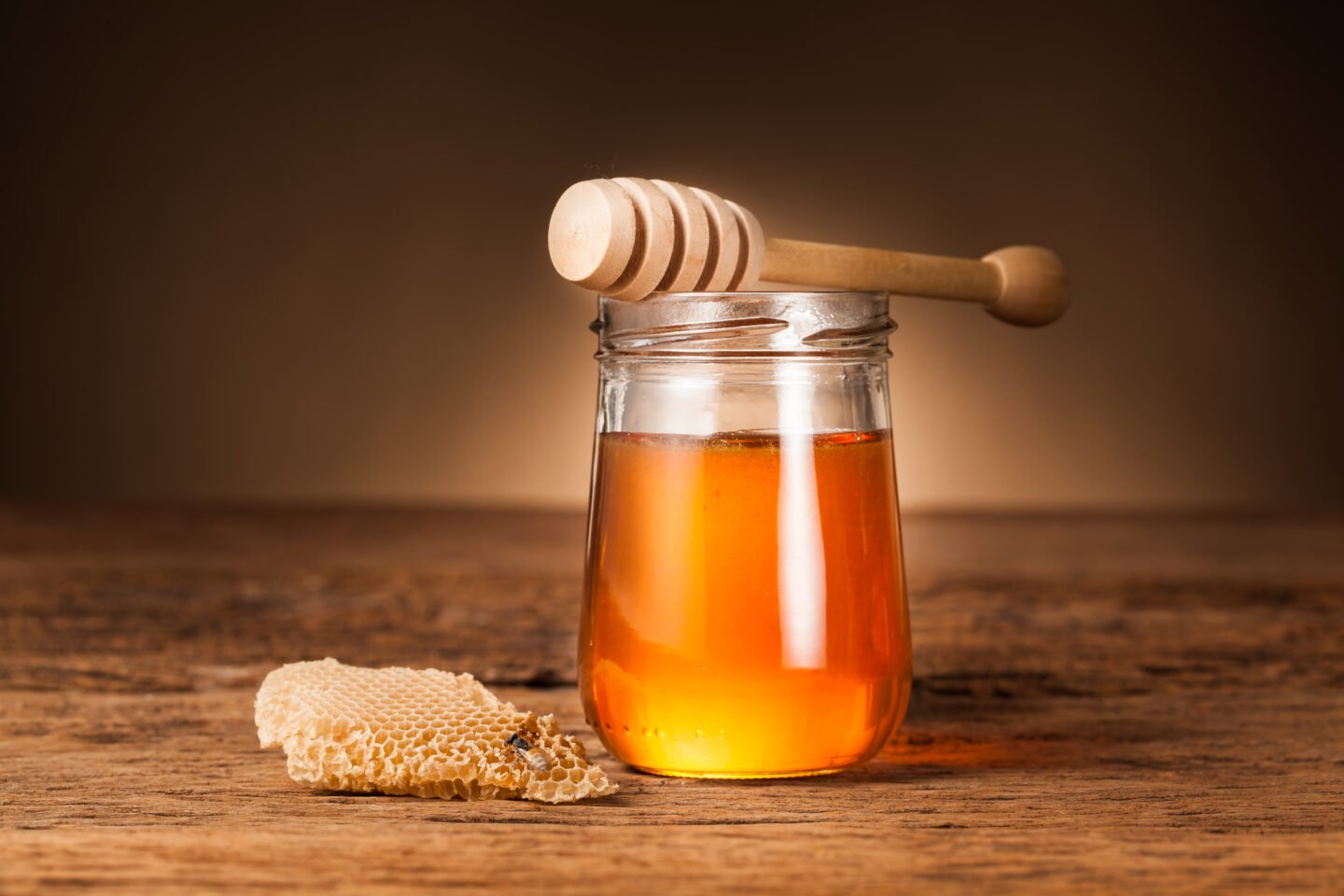 Honey,Pot,Preserved,With,Honeycomb,On,Wood,Background