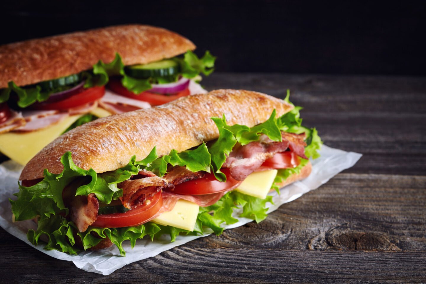 submarine sandwiches on dark wood