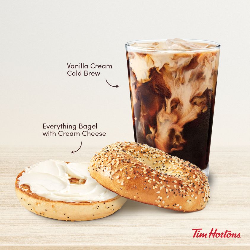 tim hortons glass of vanilla cold cream brew with everything bagel on table