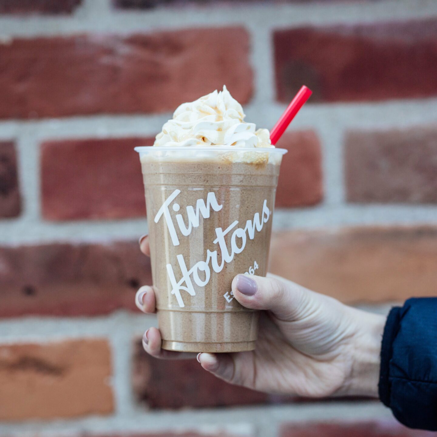 tim hortons hand holding takeaway caramel iced capp