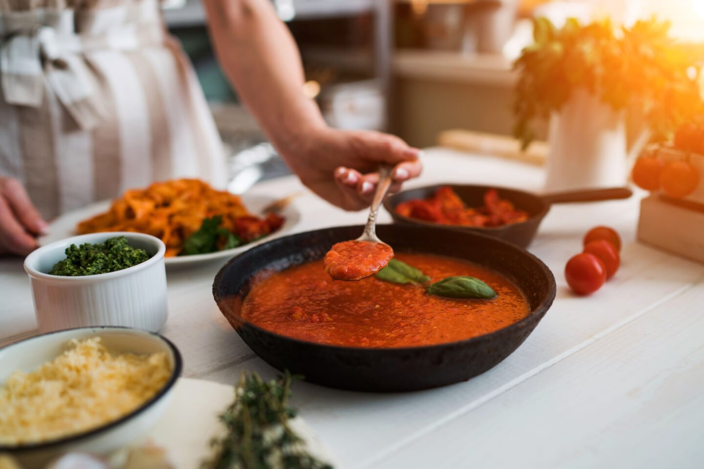 woman makes homemade tomato sauce for pasta