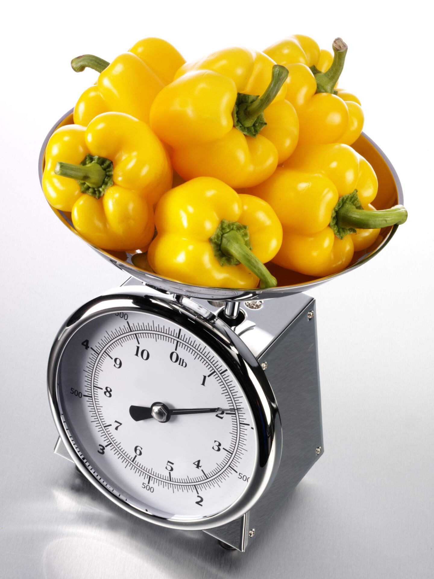 yellow bell peppers on a kitchen scale