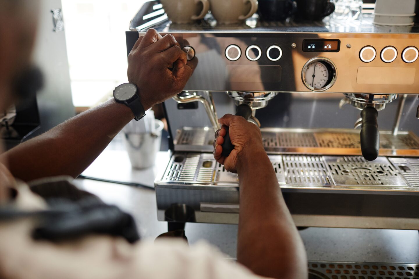 High,Angle,Shot,Of,Unrecognizable,Barista,Adjusting,Settings,On,Professional