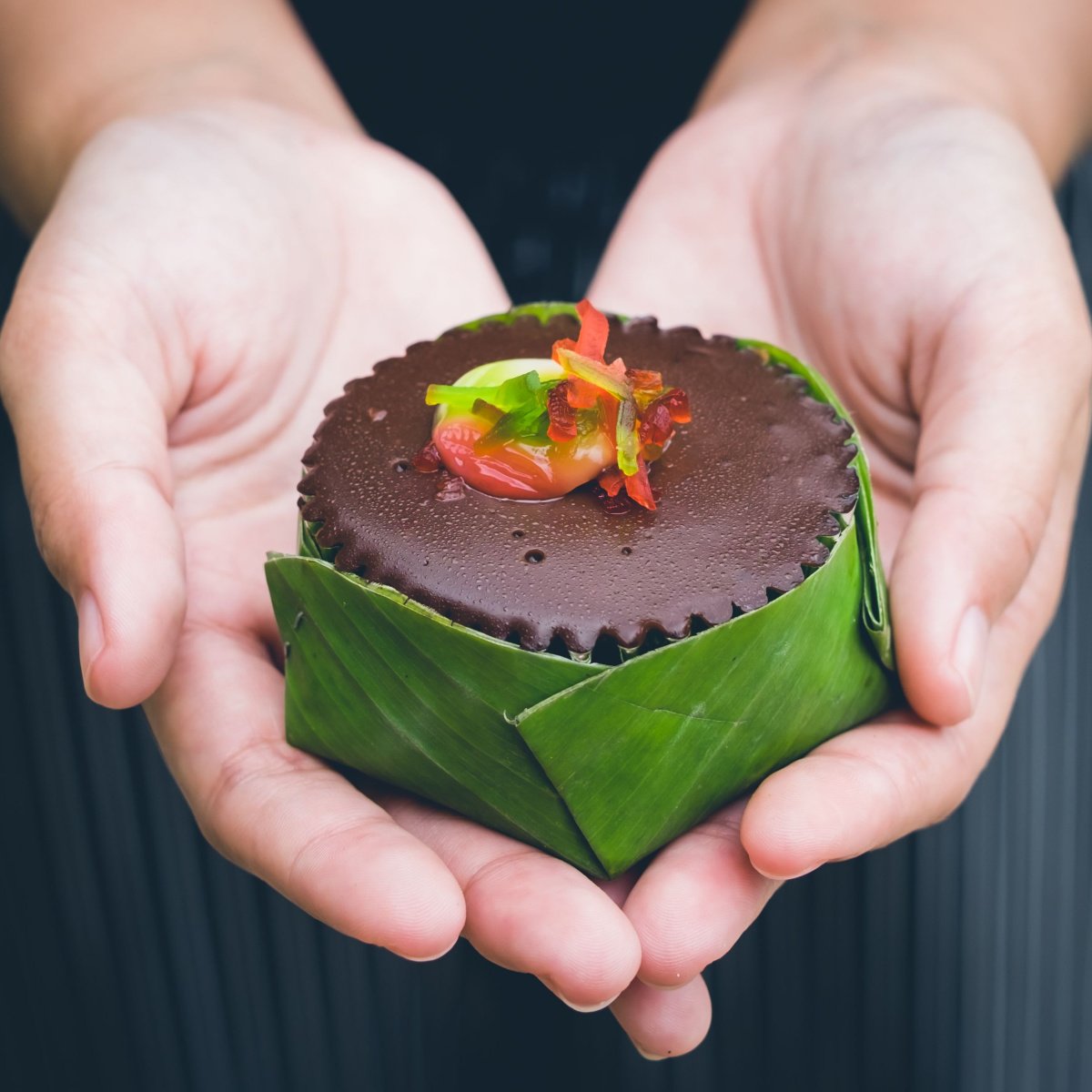 brownie cupcake wrapped in banana leaf