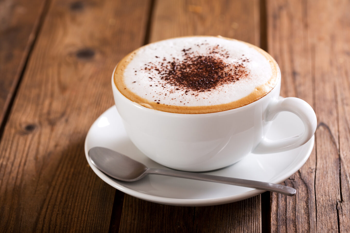 Cup,Of,Cappuccino,Coffee,On,Wooden,Table