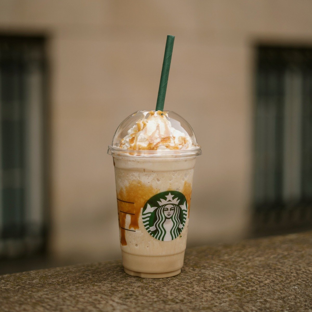 cup of starbucks frappuccino on stone pavement