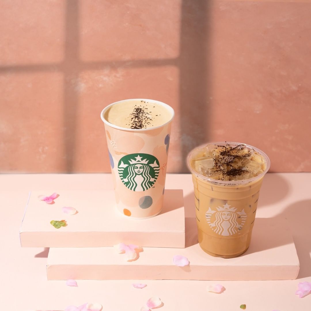 cup of starbucks smoked butterscotch latte beside iced smoked butterscotch