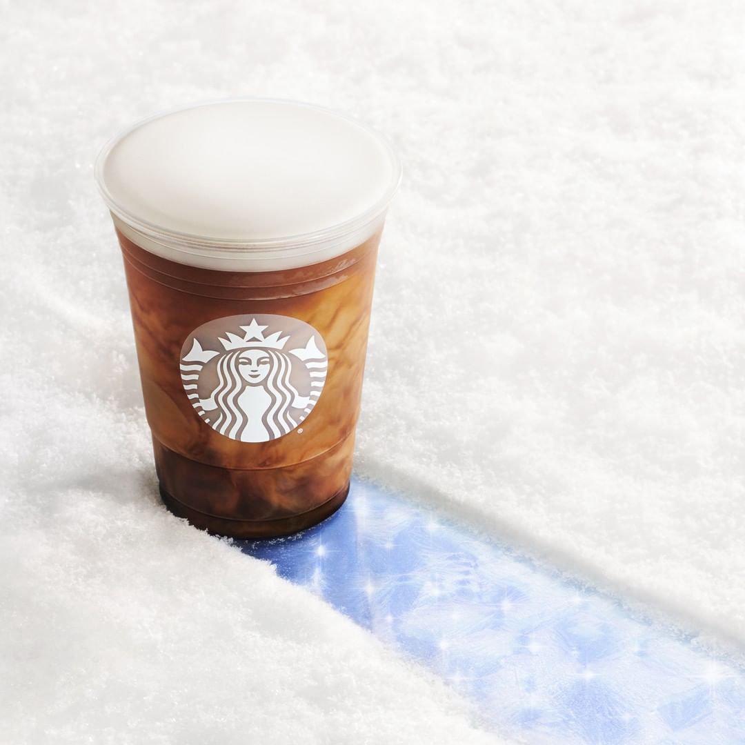 cup of starbucks vanilla sweet cream nitro cold brew surrounded by fluffy surface
