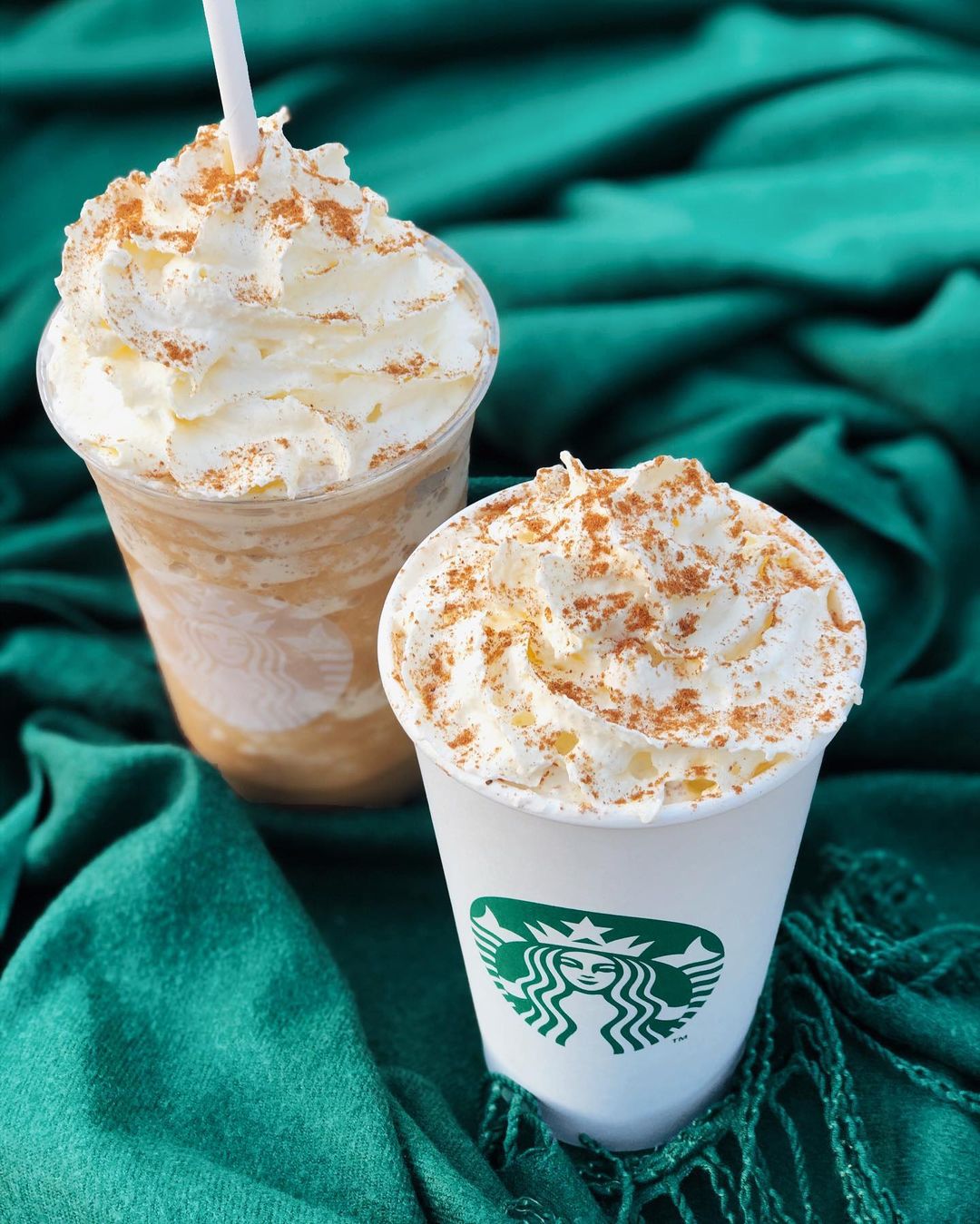 cups of starbucks iced cinnamon dolce latte beside cinnamon dolce latte