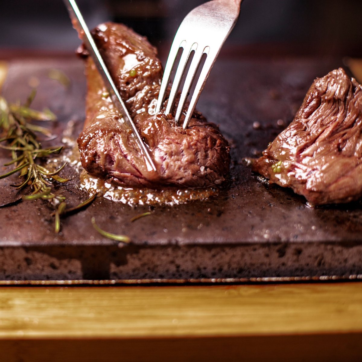 cutting through sirloin steak