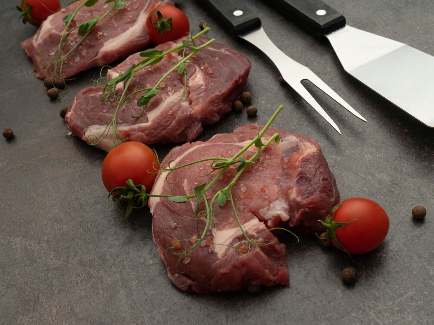 dark colored steaks with tomatoes