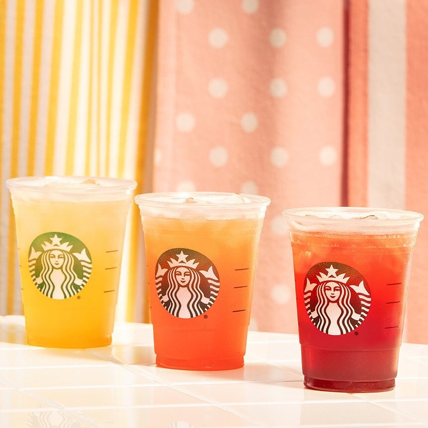 few types of starbucks iced teas in cups on white surface