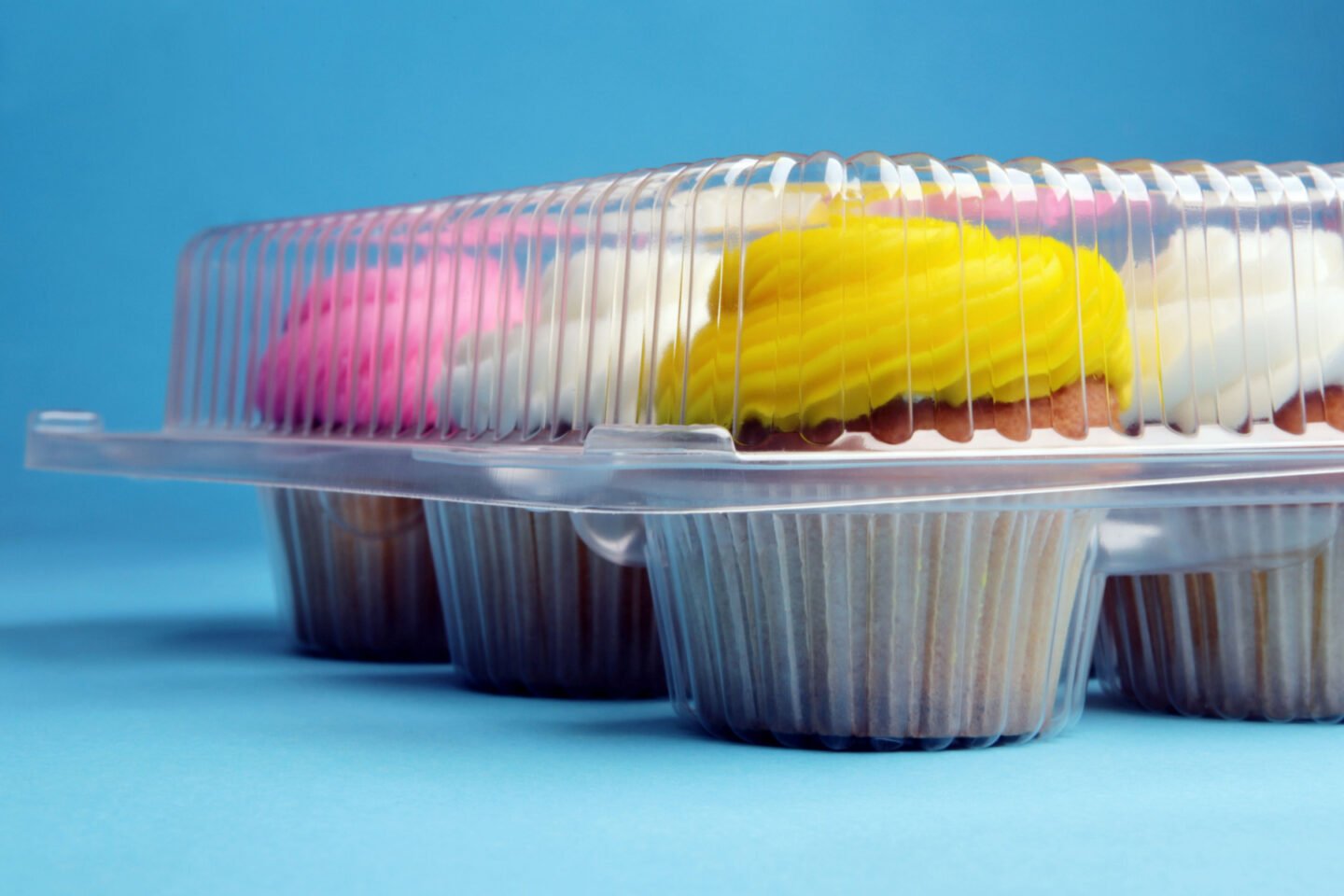 frosted cupcakes in transparent container