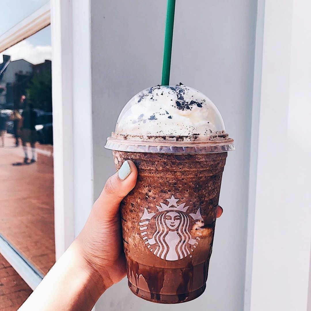 hand holding cup of starbucks mocha cookie crumble frappuccino