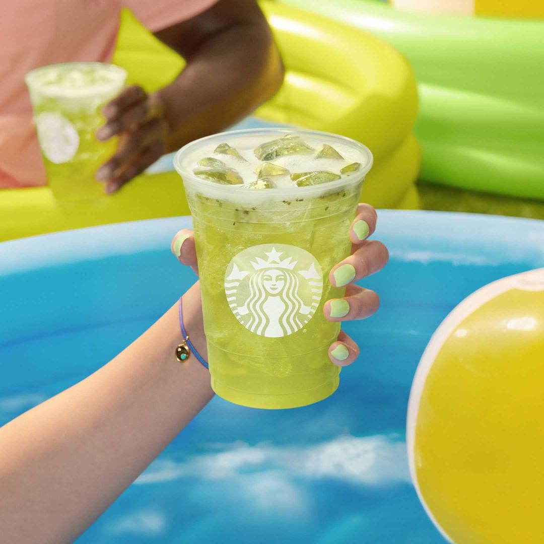 hand holding up kiwi starfruit starbucks refresher drink