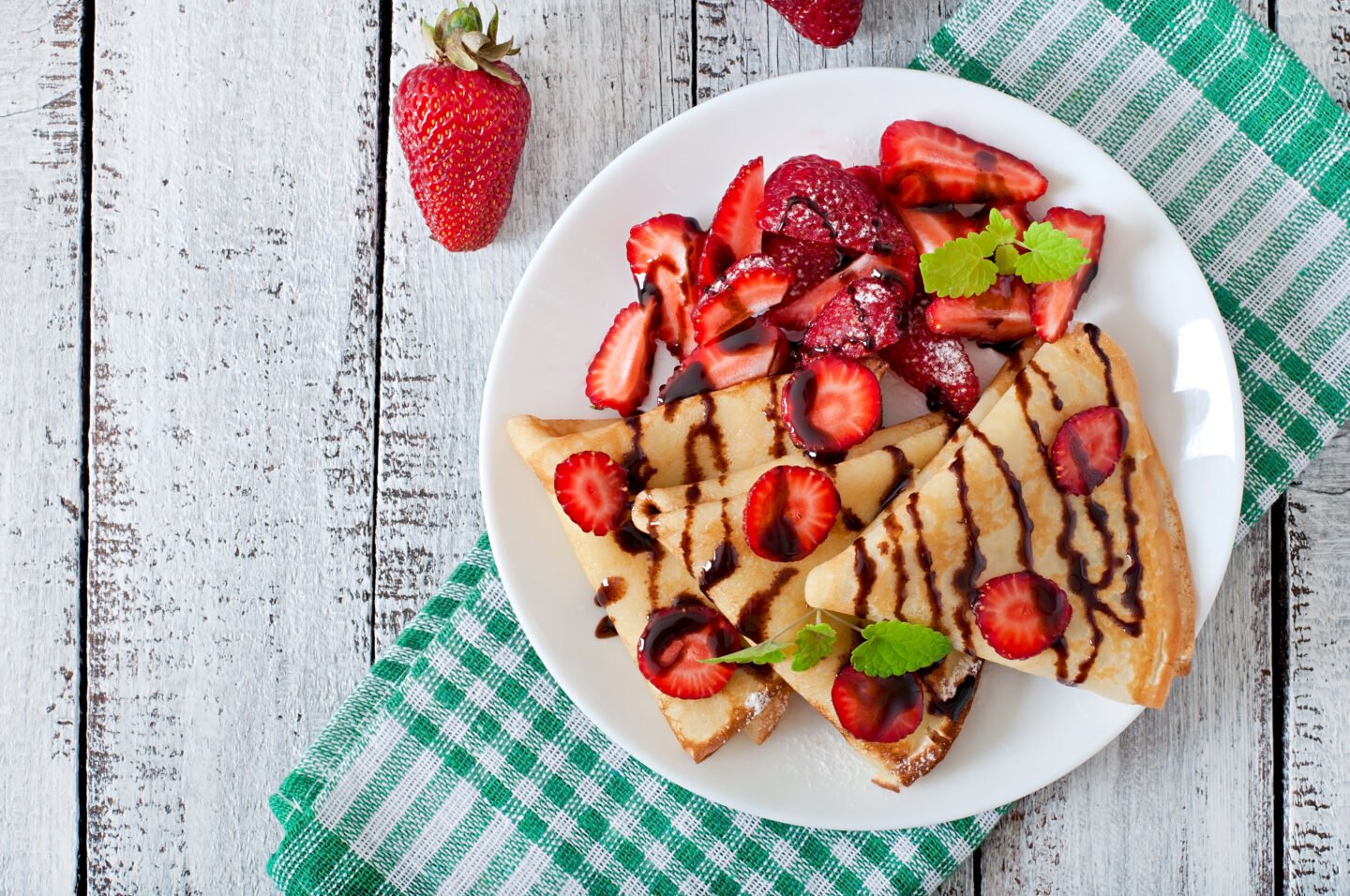 Pancakes,With,Strawberries,And,Chocolate,Decorated,With,Mint,Leaf.,Top