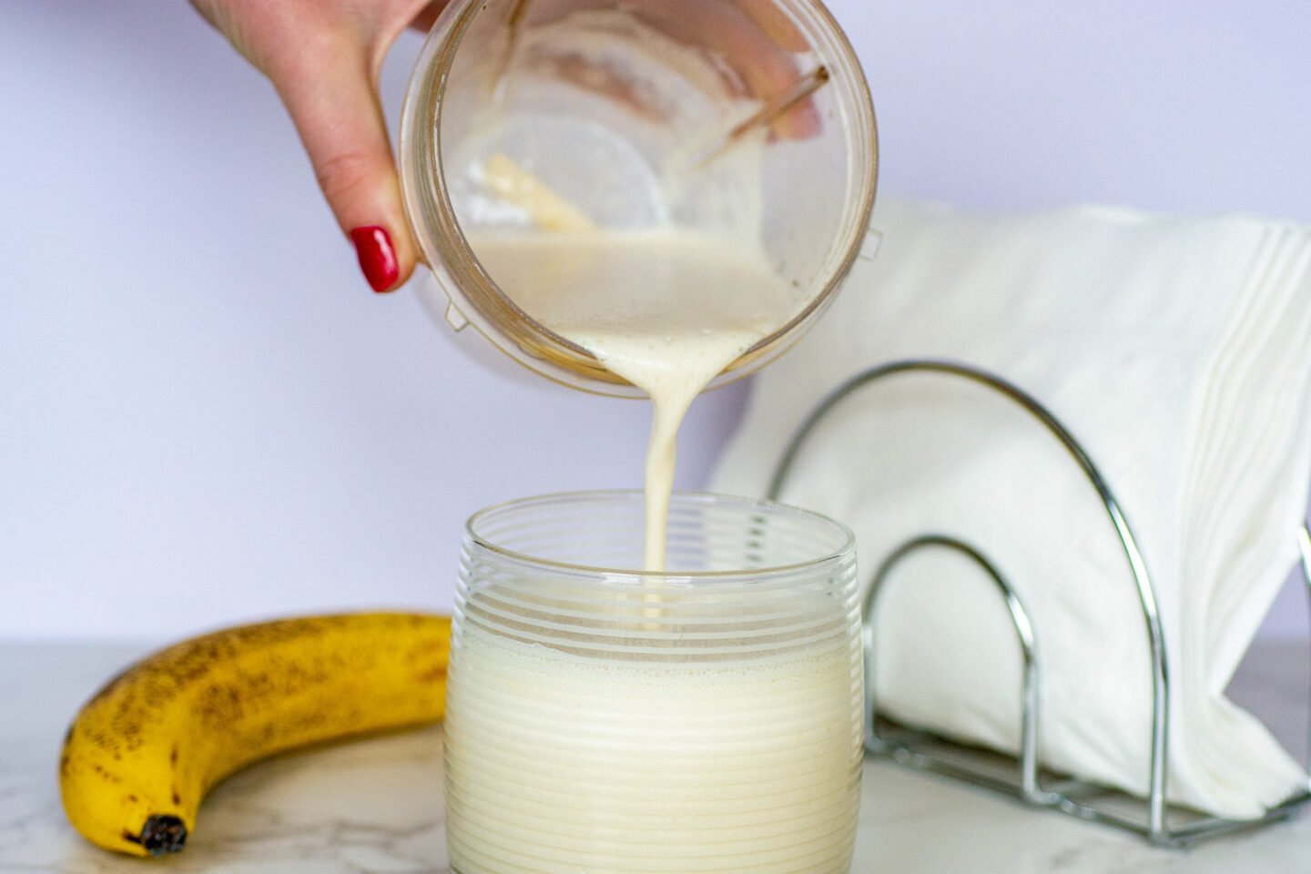 pouring korean banana milk into a glass