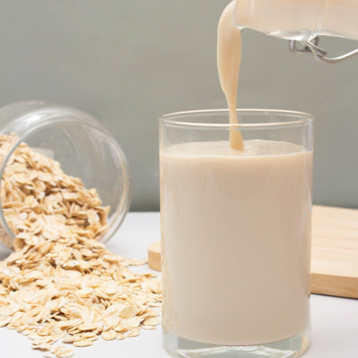 pouring oat milk into glass