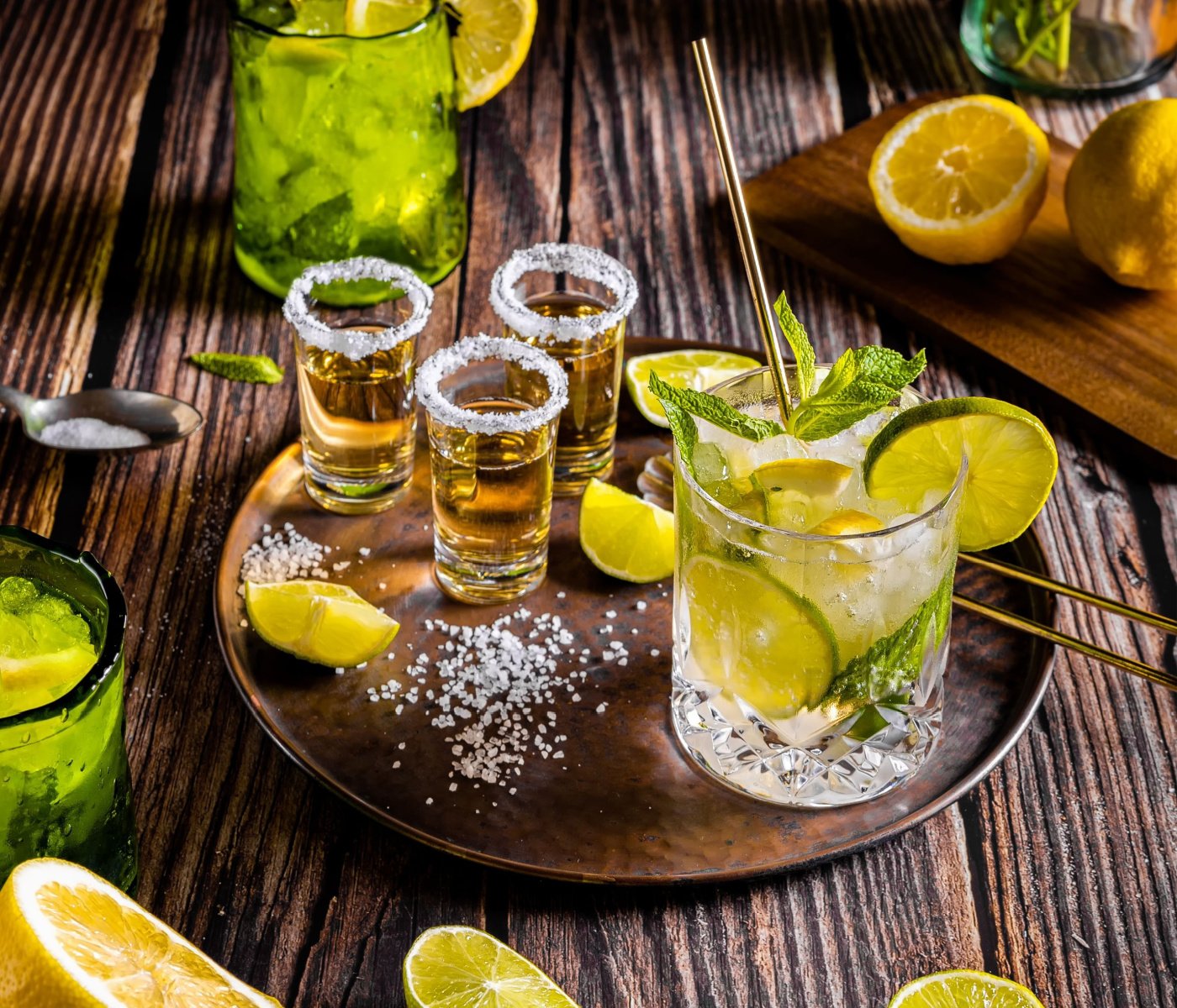 serving tequila with citrus in salt rimmed glasses