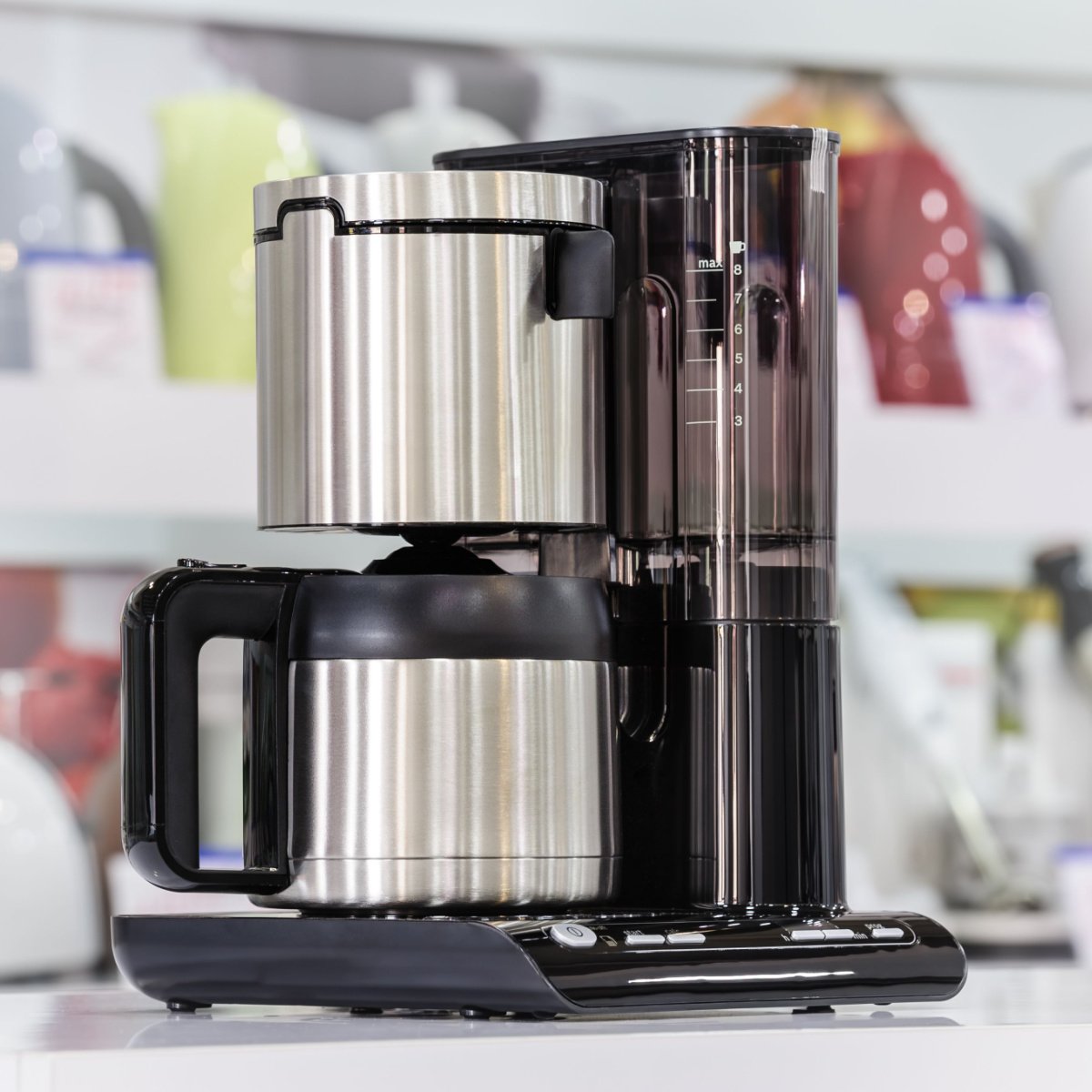 stainless steel thermal coffee maker on countertop