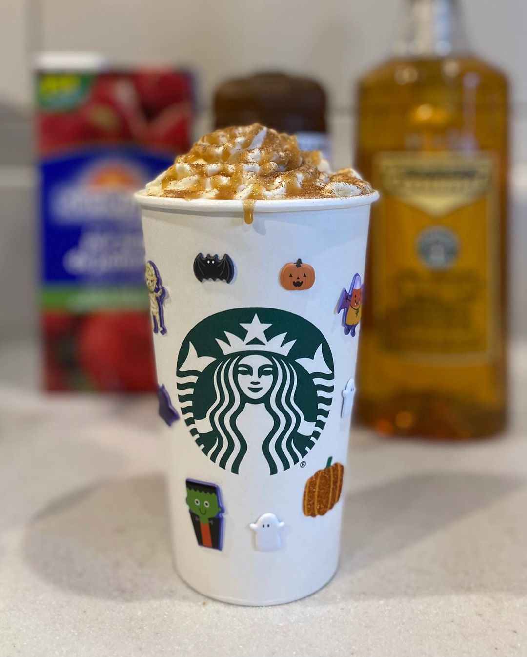 starbucks caramel apple spice drink in takeaway cup with stickers