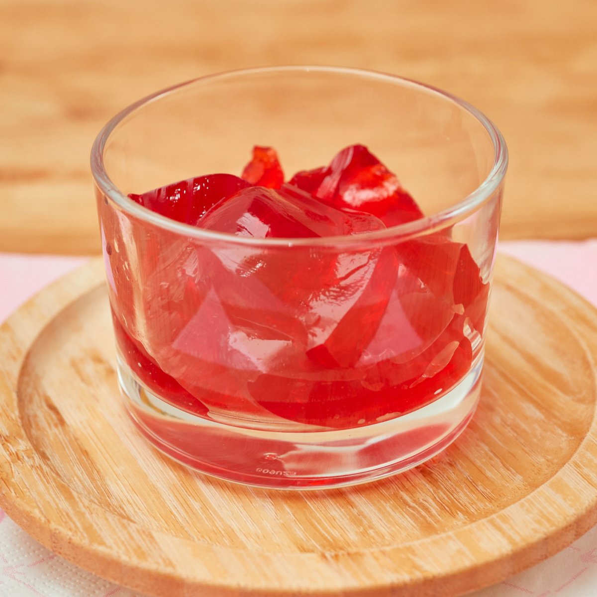 strawberry jello cubes in small glass cup