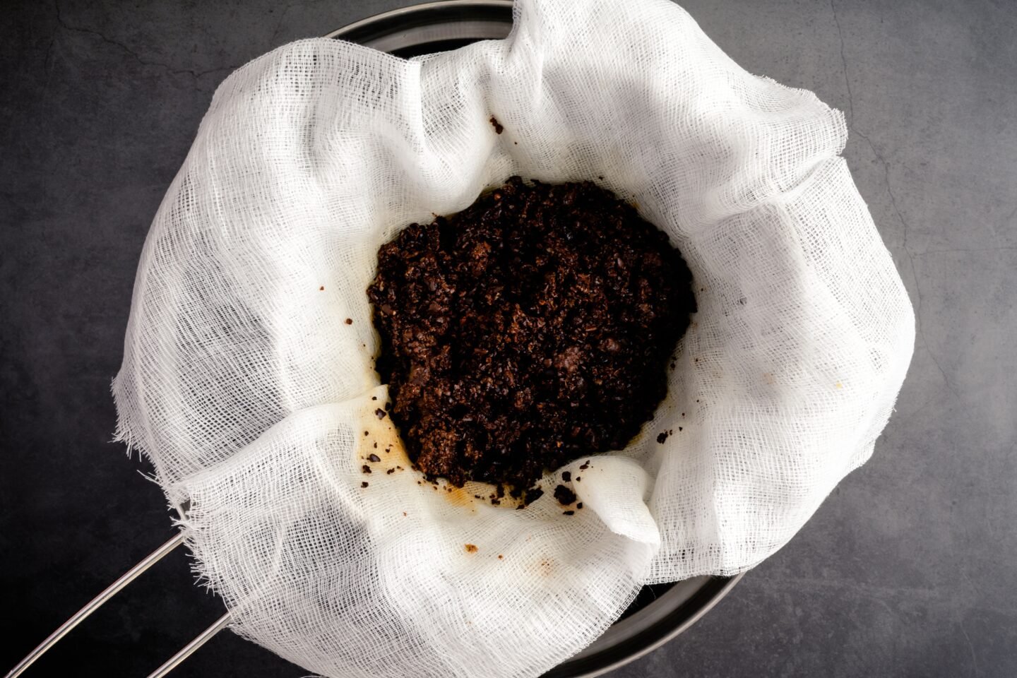 Used,Coffee,Grounds,In,A,Cheesecloth,Lined,Strainer:,Coffee,Grounds
