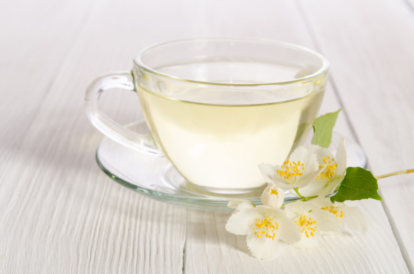 Glass,Cup,Of,Tea,With,Jasmine,On,The,White,Wooden